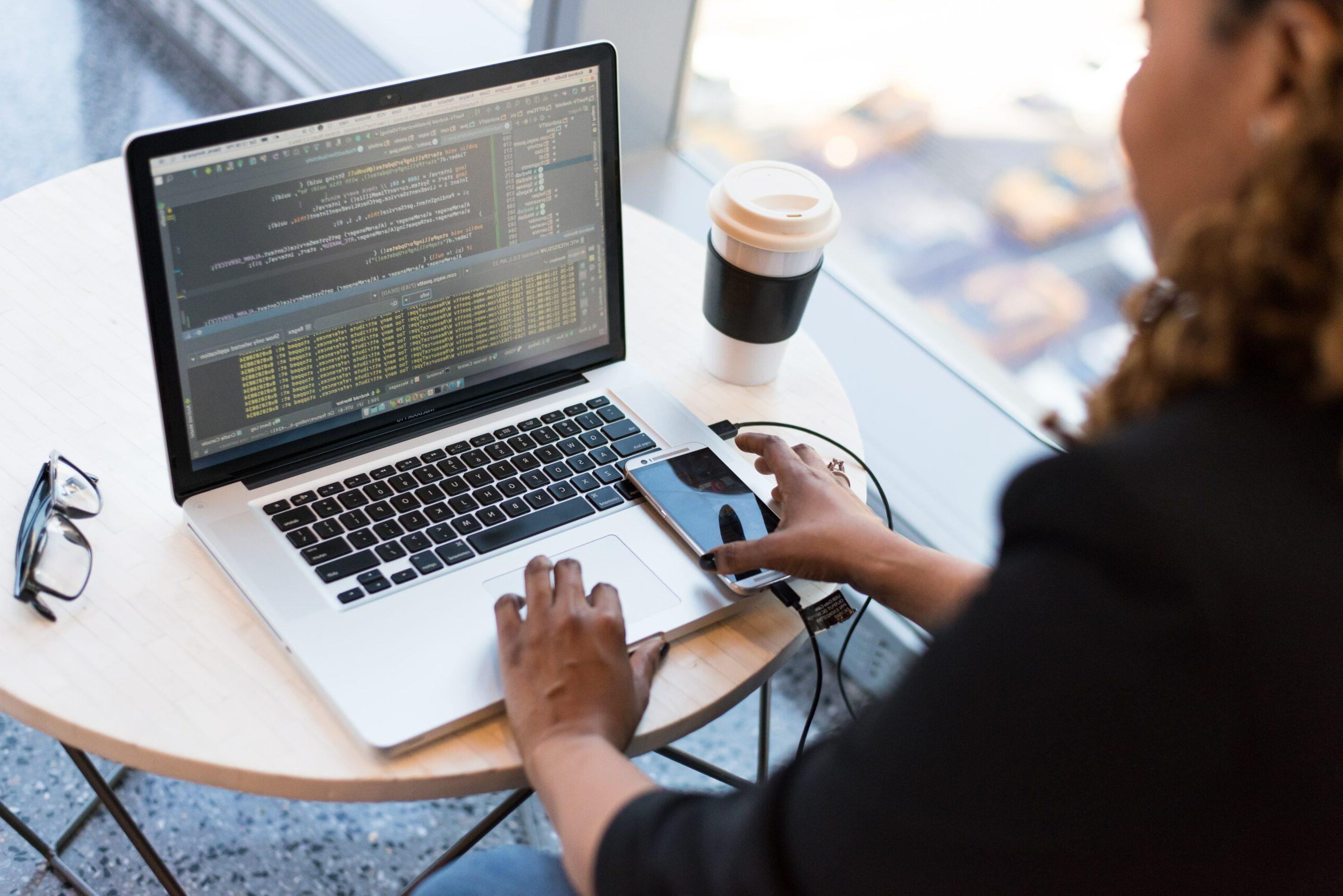 Woman coding on her laptop